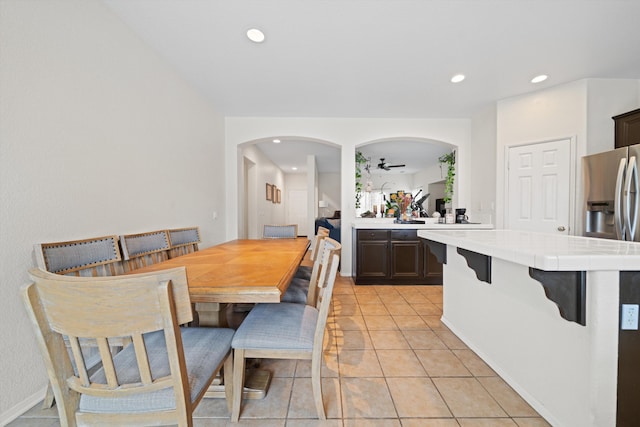 tiled dining room featuring ceiling fan