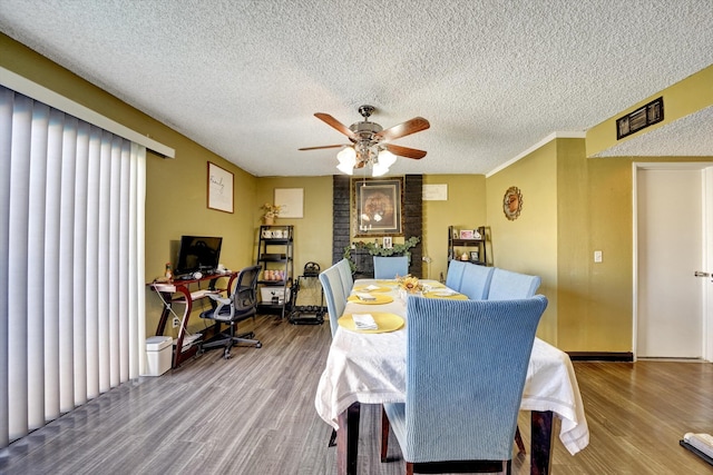 dining space featuring ceiling fan, a textured ceiling, and hardwood / wood-style flooring