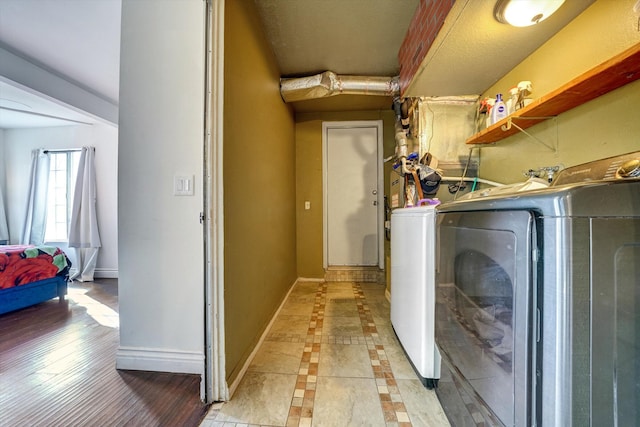 clothes washing area featuring independent washer and dryer and light tile patterned floors