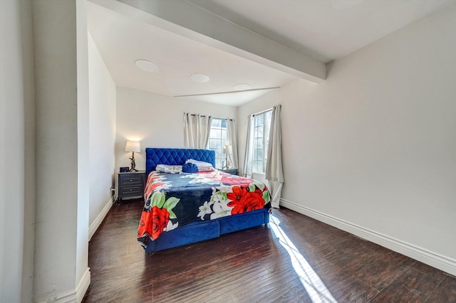 bedroom featuring beam ceiling and dark wood-type flooring