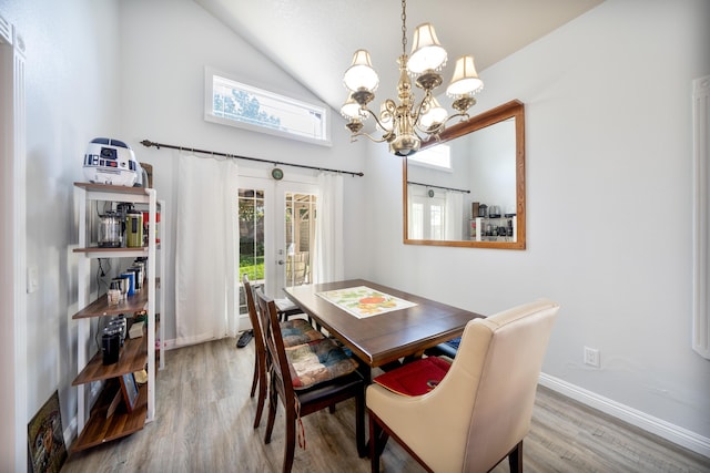 dining room featuring an inviting chandelier, high vaulted ceiling, french doors, baseboards, and wood finished floors