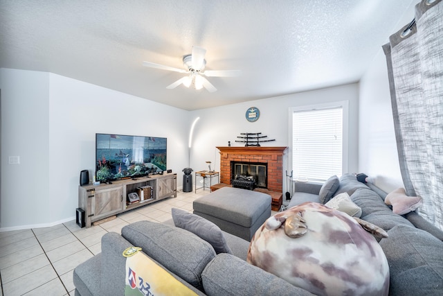 living room featuring baseboards, ceiling fan, and light tile patterned flooring