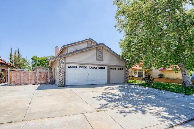 view of front of property with an attached garage, stone siding, a gate, a chimney, and concrete driveway