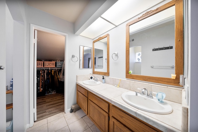 full bathroom featuring a sink, tile patterned floors, double vanity, and visible vents