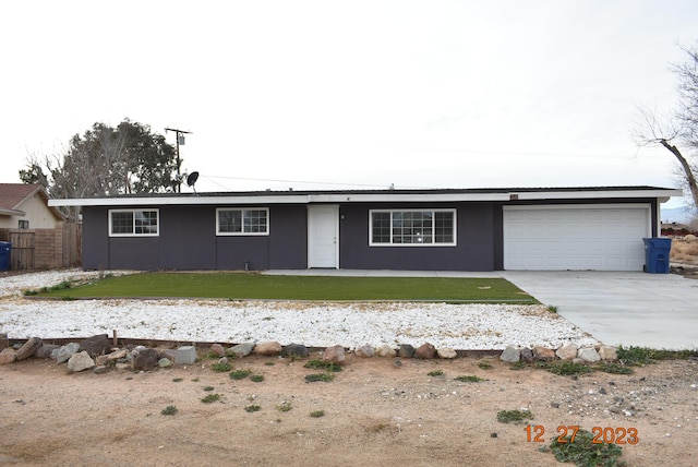 single story home featuring a garage and a front yard