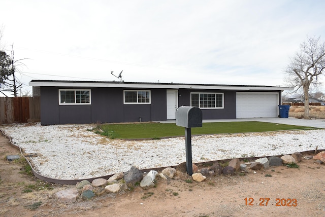 ranch-style house with a garage and a front lawn