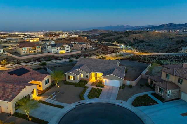 aerial view at dusk featuring a mountain view