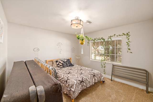 bedroom featuring visible vents, carpet flooring, and baseboards