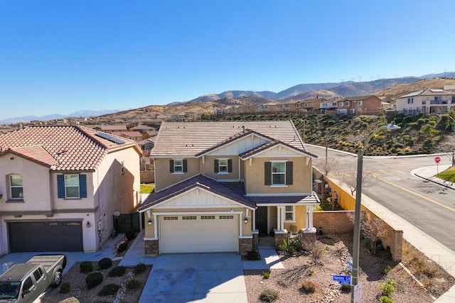 view of front of property featuring a garage and a mountain view