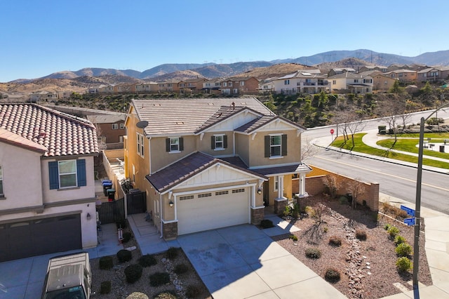 view of front of property featuring a garage and a mountain view