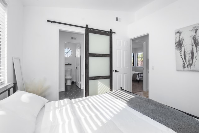 2012 Comstock Ct, Palmdale, CA 93551 - bedroom featuring a barn door and connected bathroom