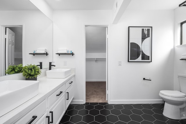 2012 Comstock Ct, Palmdale, CA 93551 - bathroom featuring double vanity, toilet, baseboards, and tile patterned floors