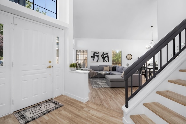 2012 Comstock Ct, Palmdale, CA 93551 - entryway with stairway, a high ceiling, light wood-type flooring, a chandelier, and baseboards