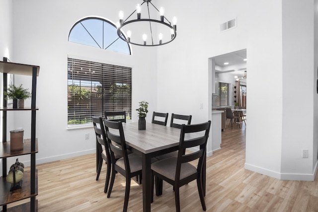 2012 Comstock Ct, Palmdale, CA 93551 - dining area with a chandelier, light wood-style floors, a high ceiling, and baseboards
