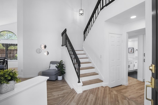 2012 Comstock Ct, Palmdale, CA 93551 - stairway featuring wood finished floors, a high ceiling, and baseboards
