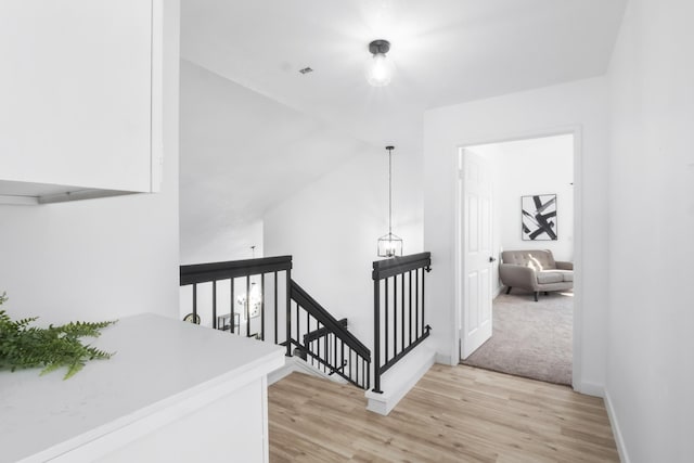 2012 Comstock Ct, Palmdale, CA 93551 - corridor featuring an upstairs landing, light wood finished floors, and baseboards