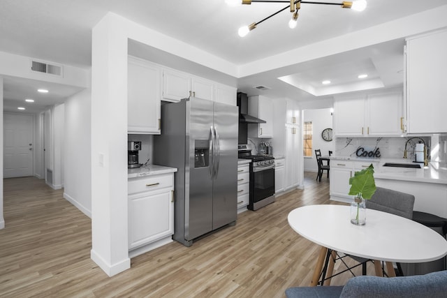 2012 Comstock Ct, Palmdale, CA 93551 - kitchen featuring stainless steel appliances, a sink, wall chimney exhaust hood, white cabinetry, and a tray ceiling