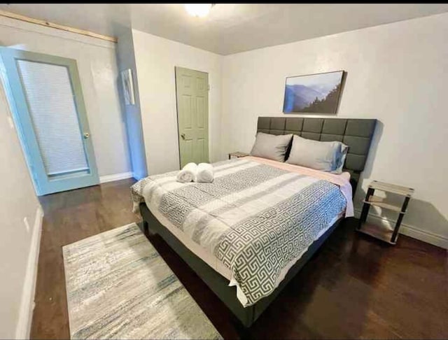 bedroom featuring baseboards and wood finished floors