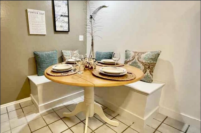 dining area with breakfast area, baseboards, and light tile patterned floors