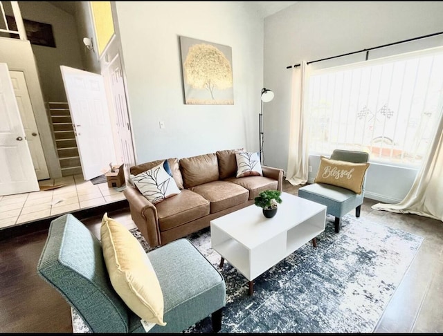 living room with stairway and a towering ceiling