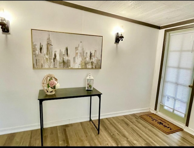 doorway featuring wood finished floors and baseboards