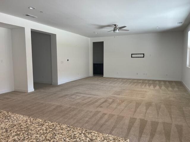 carpeted empty room featuring ceiling fan