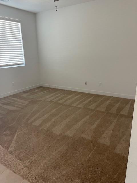 empty room with dark colored carpet