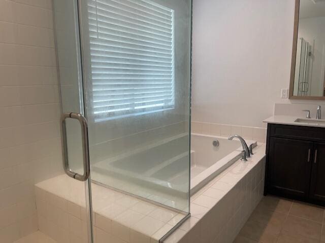 bathroom with tile patterned flooring, vanity, and separate shower and tub