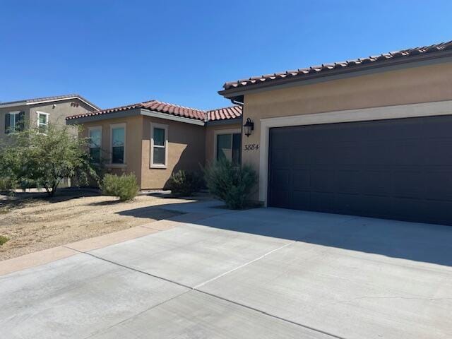 mediterranean / spanish house with a garage