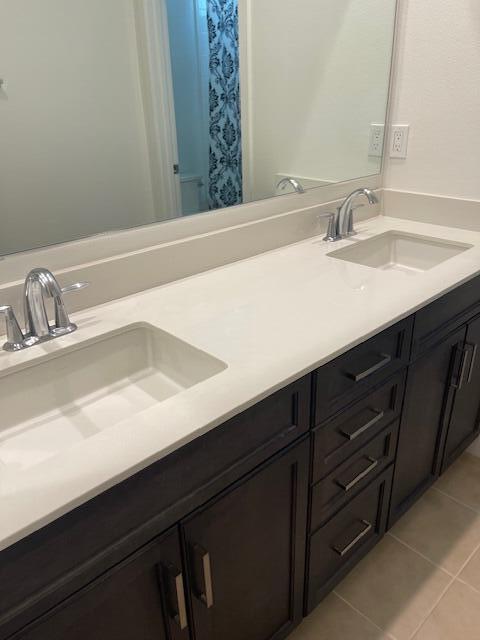 bathroom with tile patterned flooring and vanity