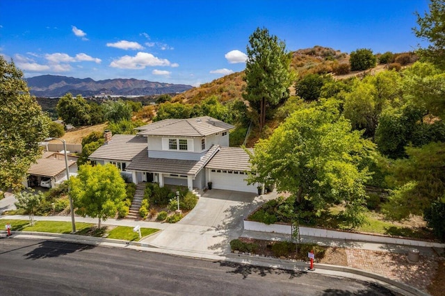 view of front of home with a garage and a mountain view