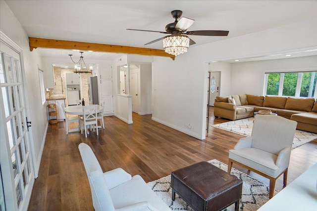 living room with ceiling fan with notable chandelier, washer / dryer, beamed ceiling, and dark hardwood / wood-style floors