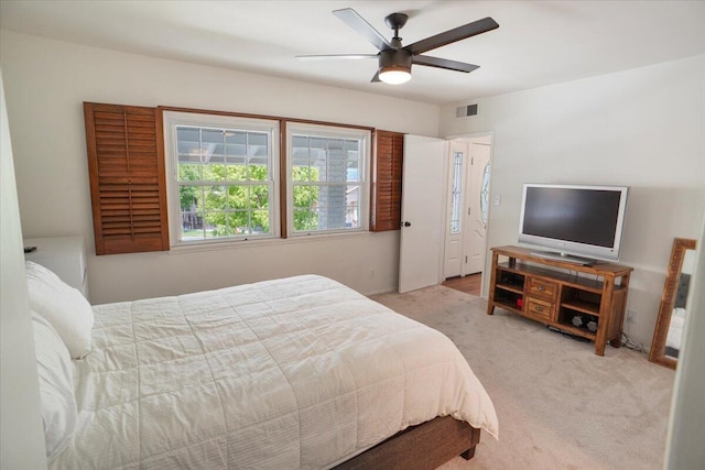 bedroom with light colored carpet and ceiling fan