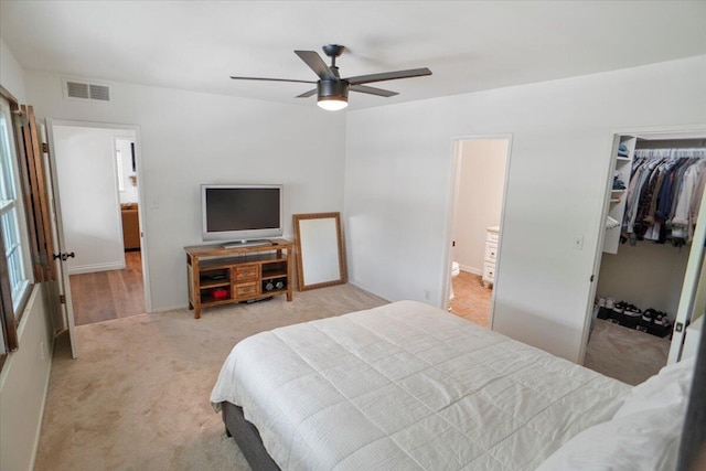 carpeted bedroom with ceiling fan and a closet