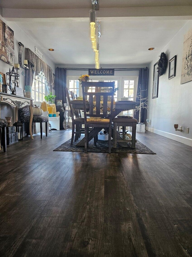 dining space with wood finished floors, a healthy amount of sunlight, and baseboards