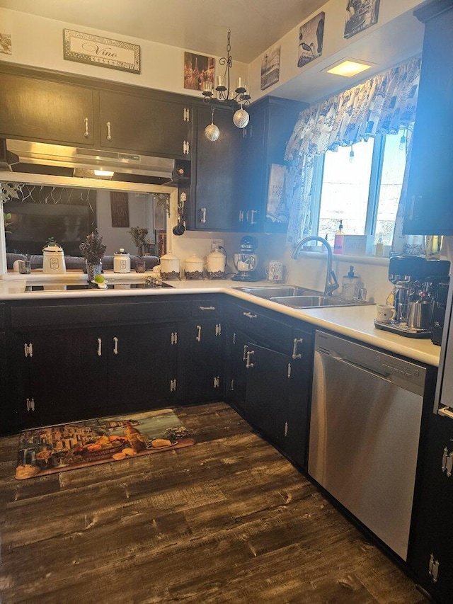 kitchen with a sink, dark wood finished floors, dishwasher, light countertops, and under cabinet range hood