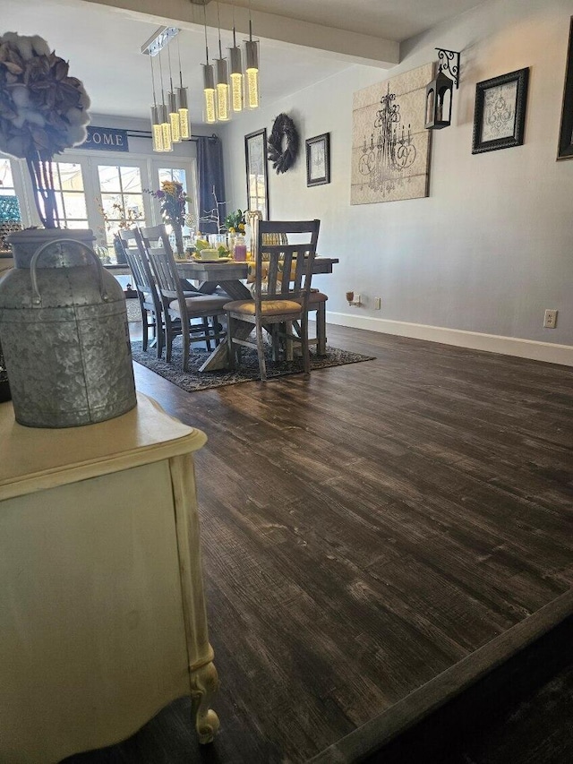 dining room with dark wood-type flooring and baseboards