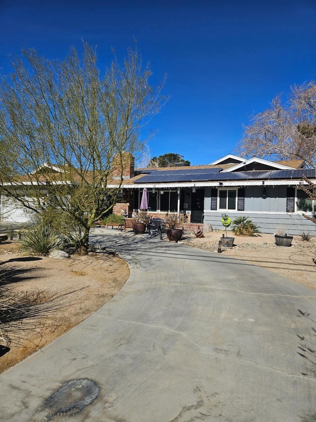 ranch-style home with solar panels