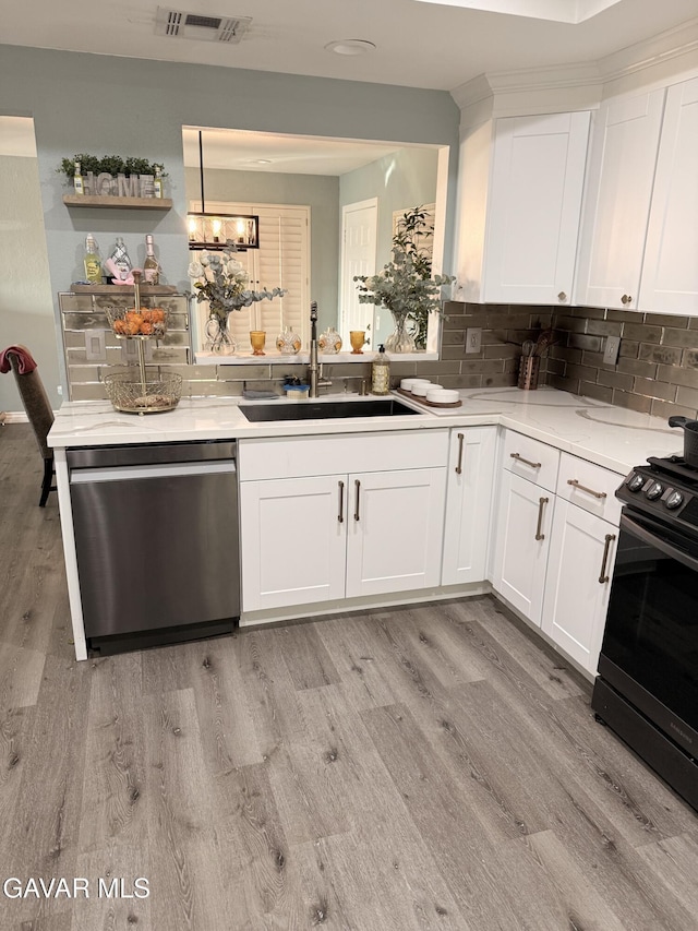 42821 W 15th St Unit 1, Lancaster, CA 93534 - kitchen featuring stainless steel dishwasher, black stove, light wood finished floors, and white cabinetry