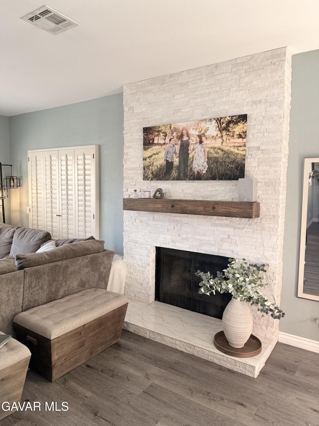 42821 W 15th St Unit 1, Lancaster, CA 93534 - living room featuring wood finished floors and a stone fireplace