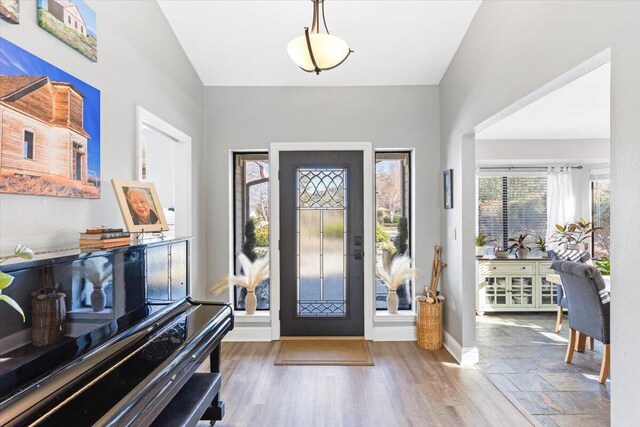 entryway featuring baseboards and wood finished floors