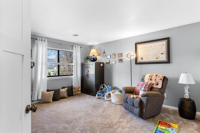 sitting room featuring carpet floors, visible vents, and baseboards