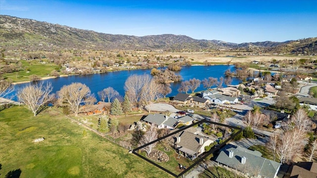 birds eye view of property featuring a water and mountain view and a residential view