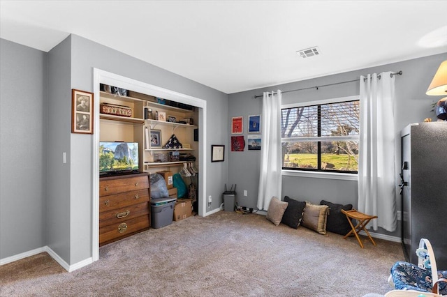 interior space featuring carpet, visible vents, and baseboards