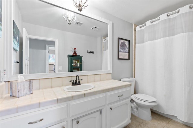 bathroom with toilet, tile patterned flooring, vanity, and visible vents