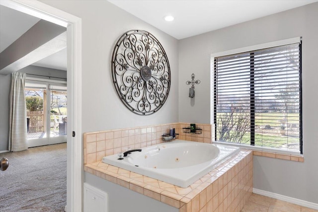 full bathroom featuring baseboards and a whirlpool tub