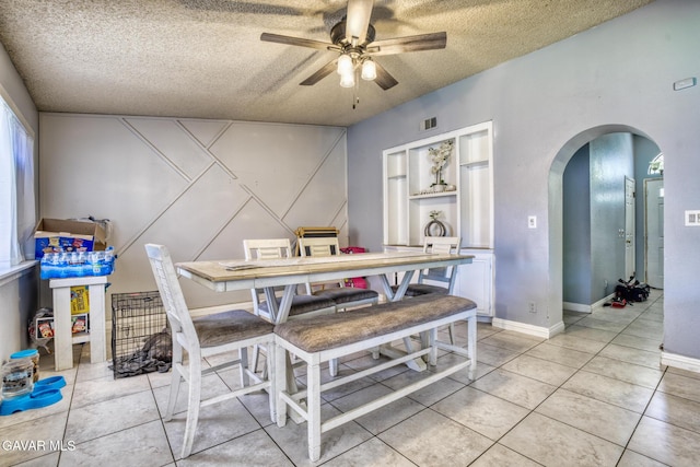 1027 James Ct, Lancaster, CA 93535 - dining area with arched walkways, a textured ceiling, ceiling fan, and light tile patterned floors