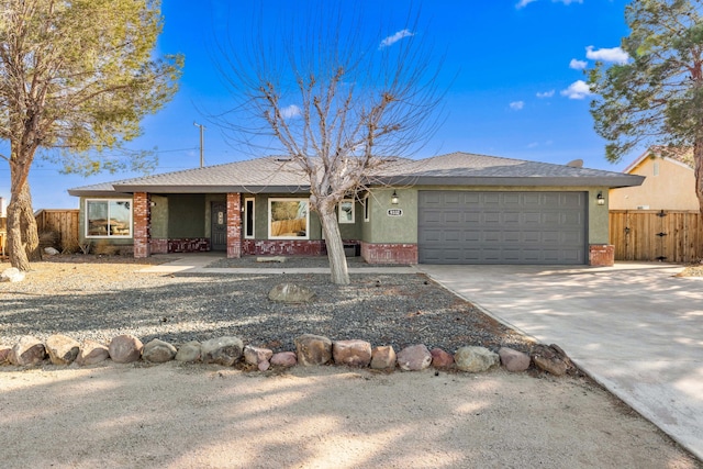 ranch-style house with stucco siding, an attached garage, concrete driveway, and fence