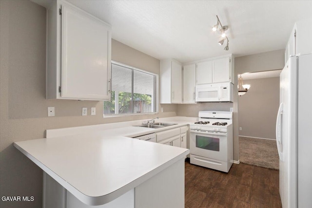 2130 Candice Ave, Rosamond, CA 93560 - kitchen featuring white appliances, a peninsula, light countertops, dark wood-type flooring, and white cabinetry