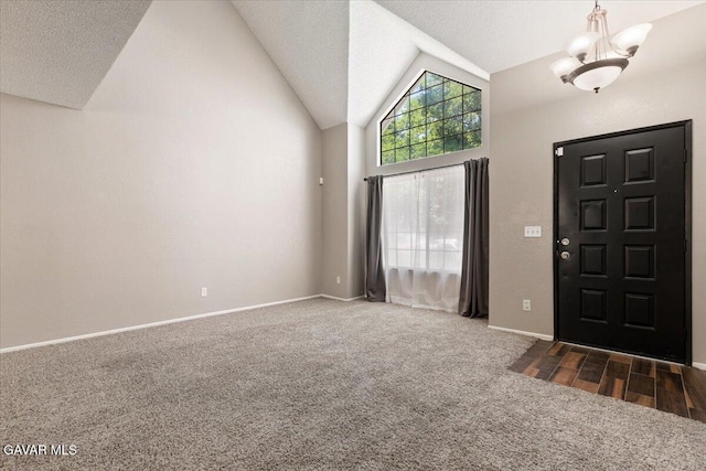 2130 Candice Ave, Rosamond, CA 93560 - entryway featuring carpet flooring, vaulted ceiling, a chandelier, and a textured ceiling